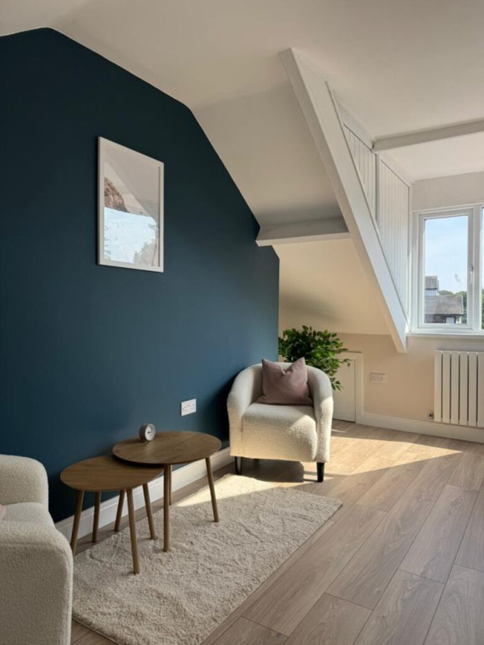 Therapy room with armchairs and a blue accent wall